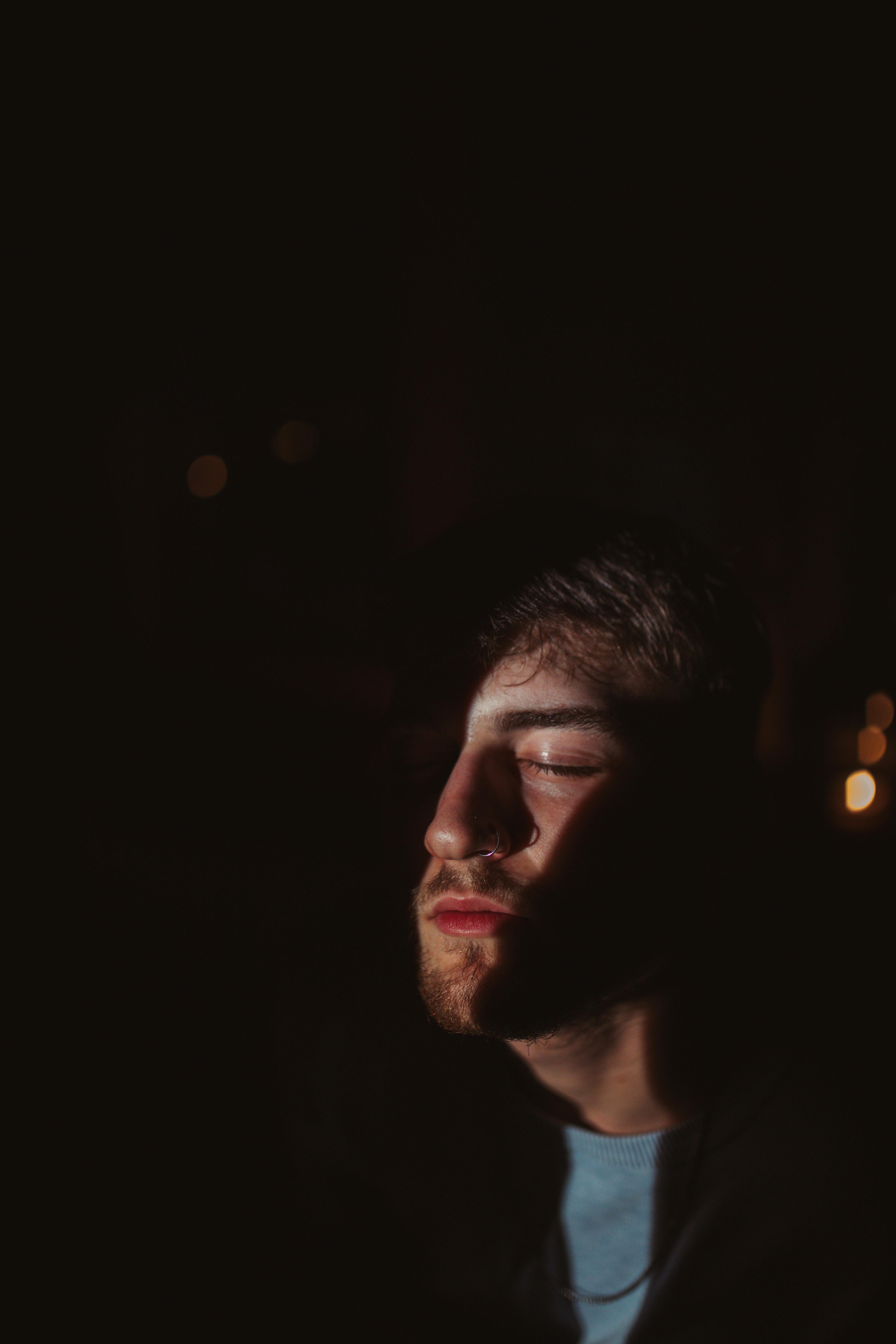Man meditating with a powerful aura of pink neon light